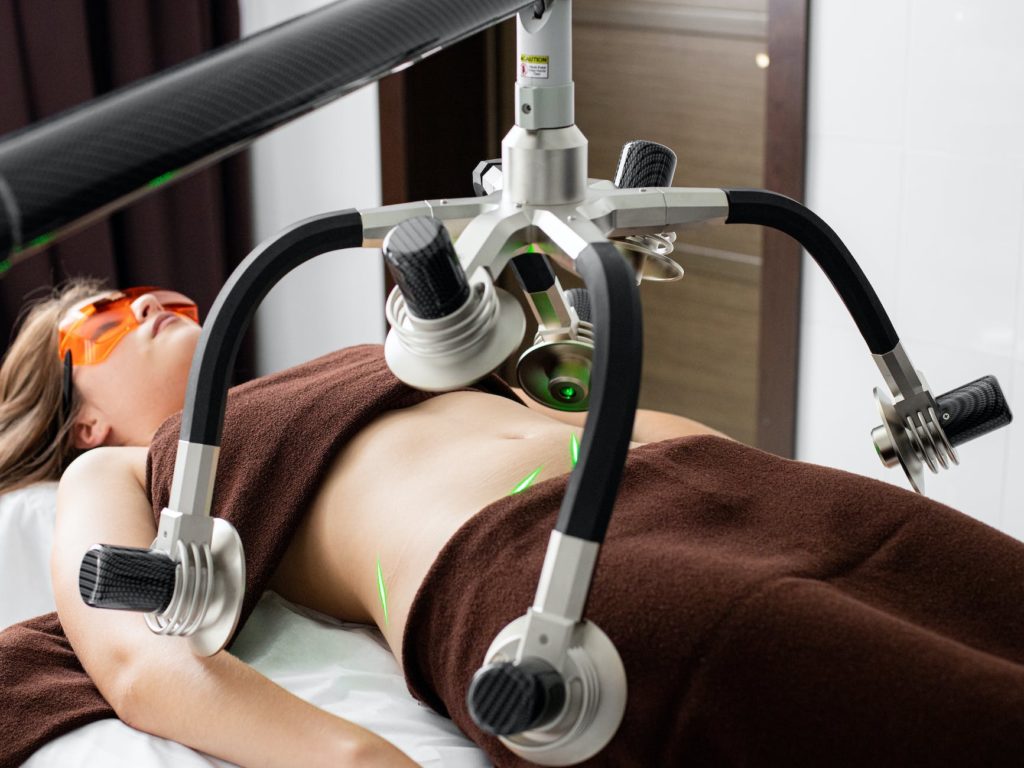 woman in eyeshades under laser fat loss machine