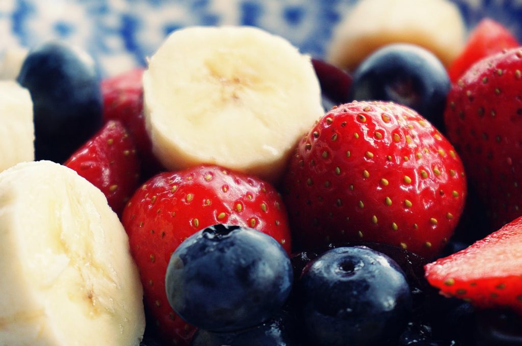 sliced strawberries banana and blackberries