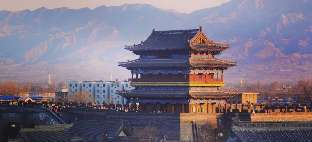 a brown building near mountains