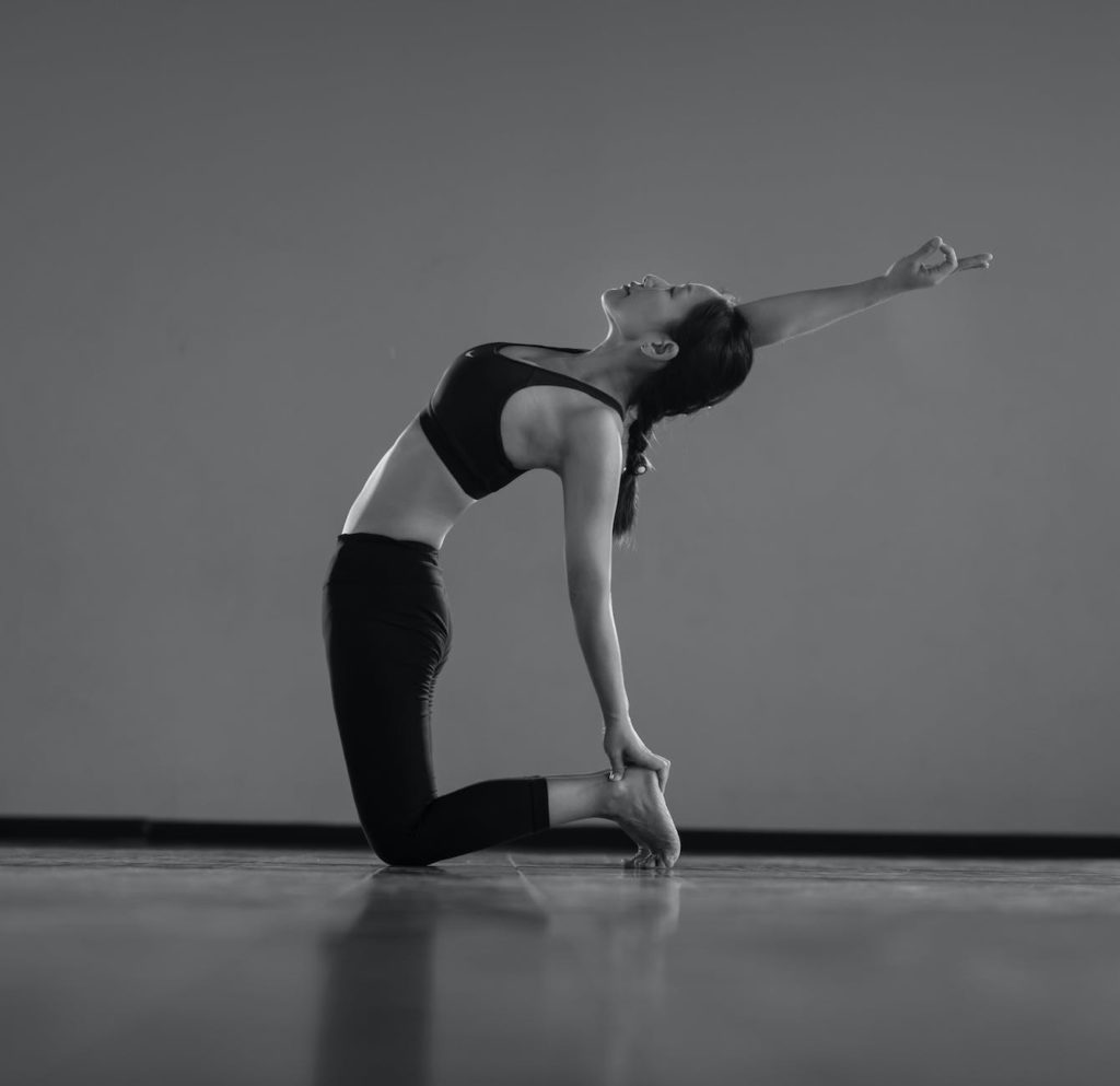 a woman doing yoga in a room