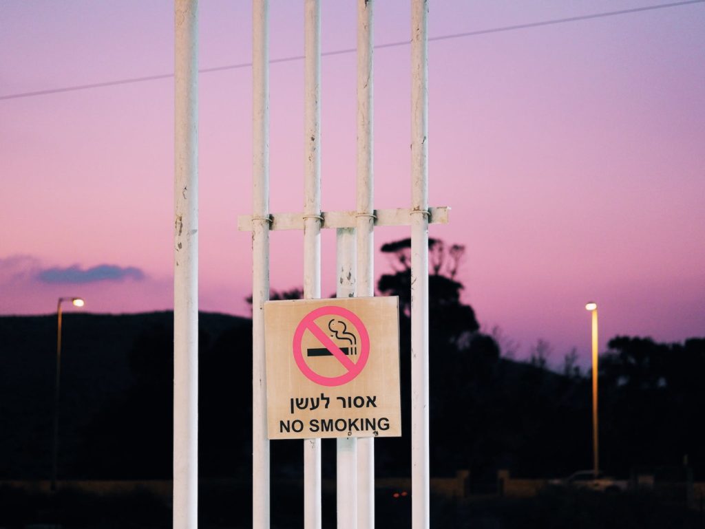 no smoking sign on steel posts