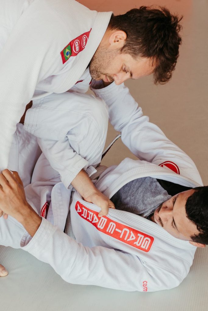 two male jiu jitsu practitioners sparring