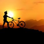 silhouette photography of biker on top of hill