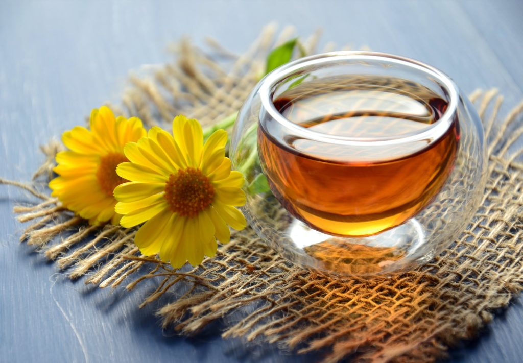 clear glass bowl beside yellow flower