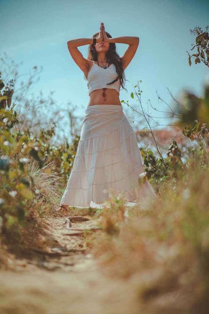 woman in white tank crop top on grass field