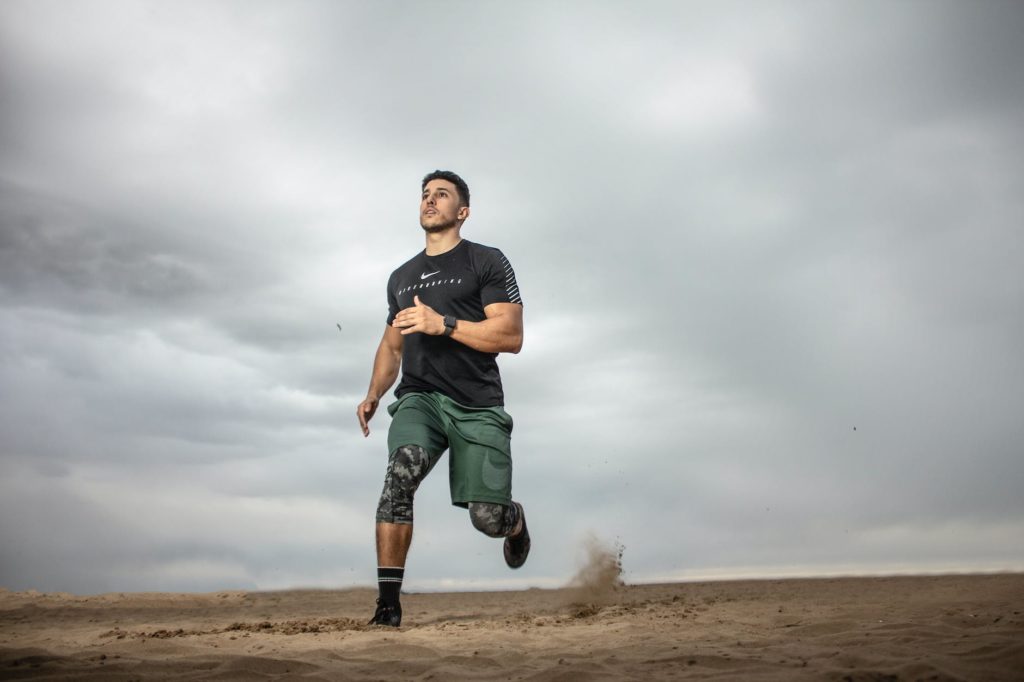 man running on sand field