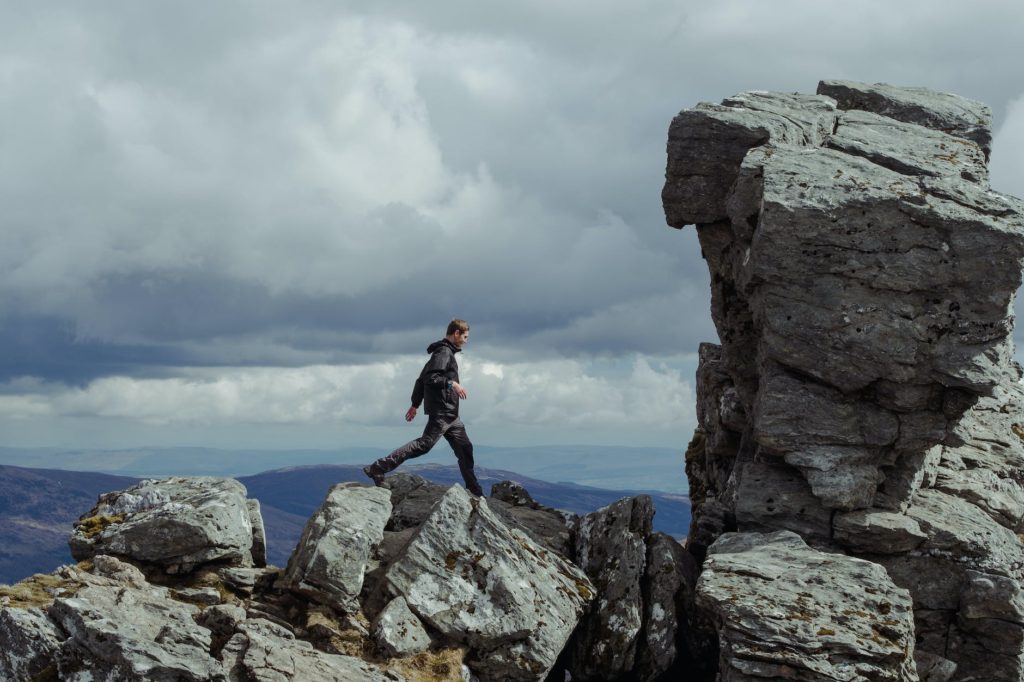 man walking on rock formations