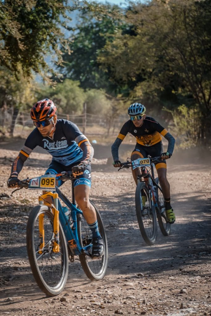 two men riding bicycle