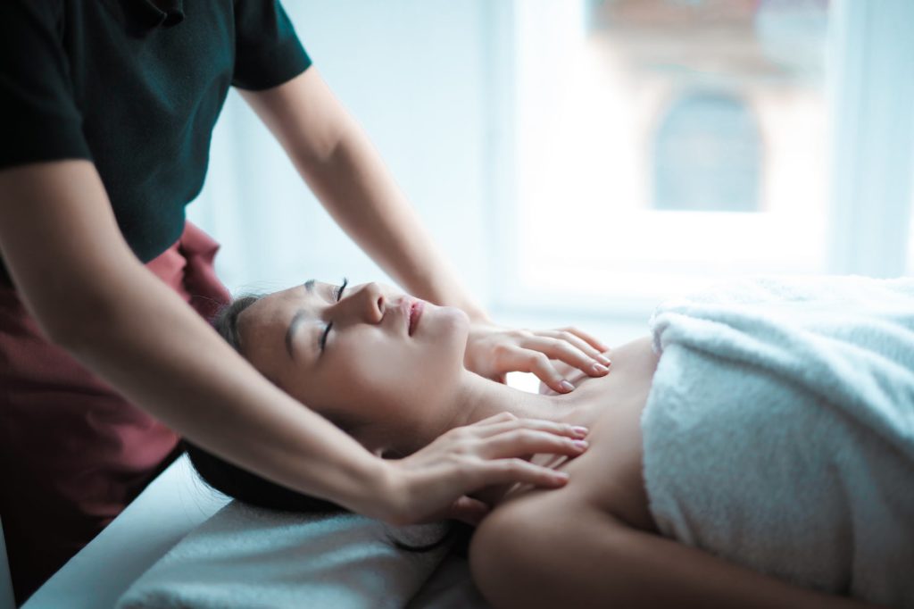 selective focus photo of woman getting a massage