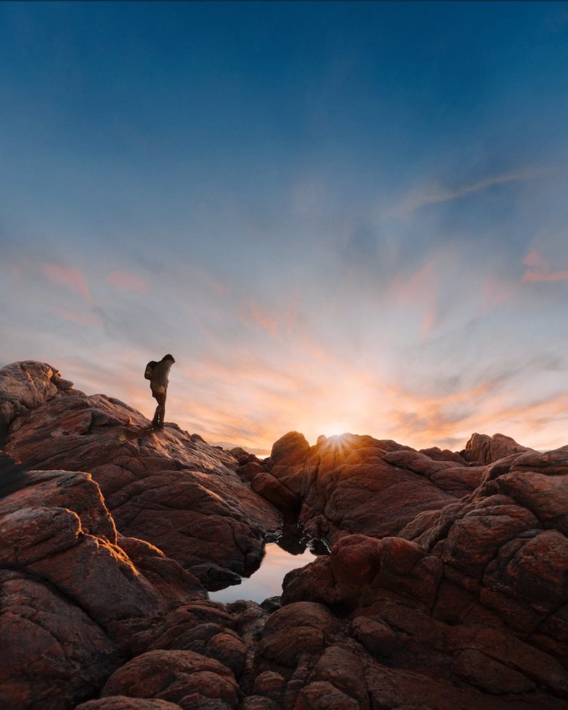 unrecognizable hiker walking through mountains