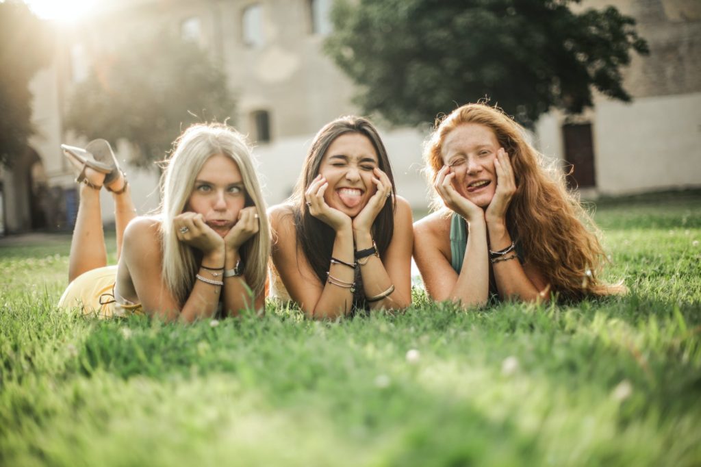 happy female friends making funny faces