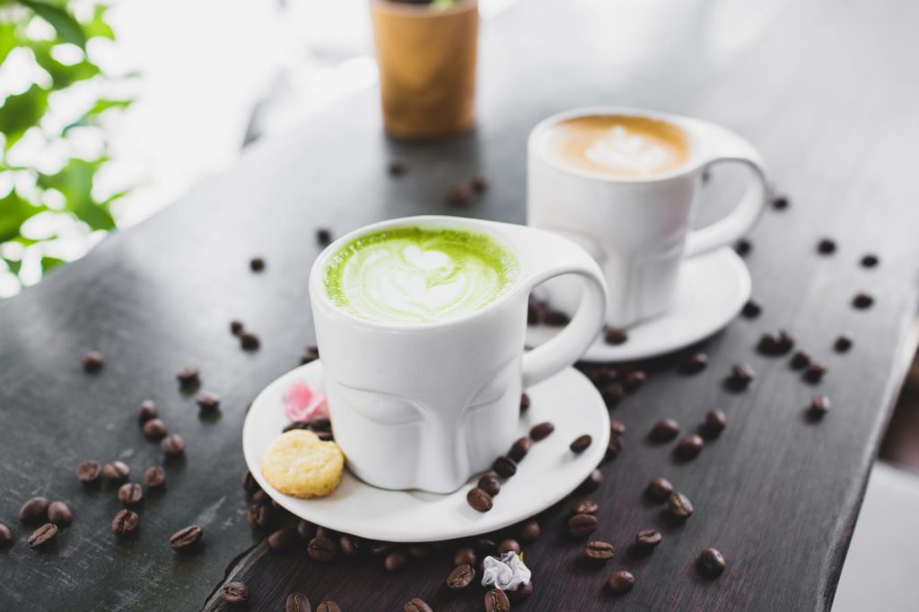 close up photo of lattes on wooden surface