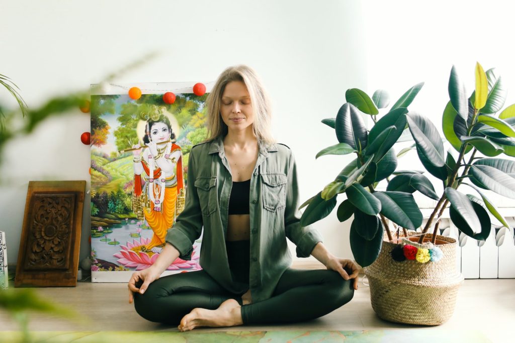 woman sitting on the floor while meditating