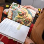 a person reading a cookbook