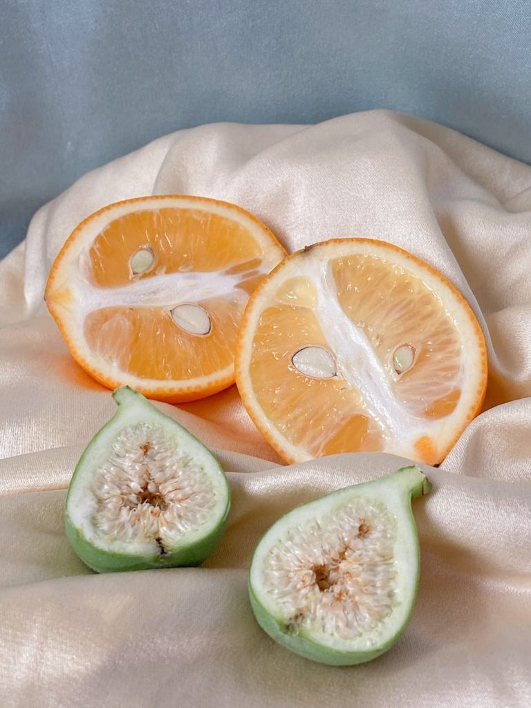 ripe chopped citrus fruits on fabric