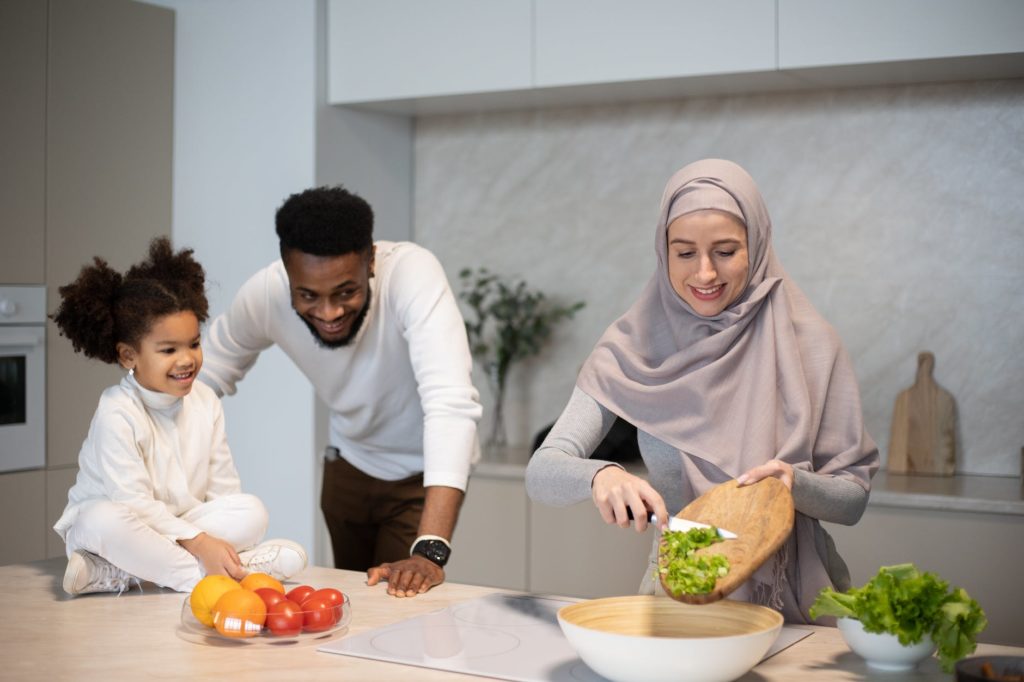 positive multiracial family cooking together in kitchen