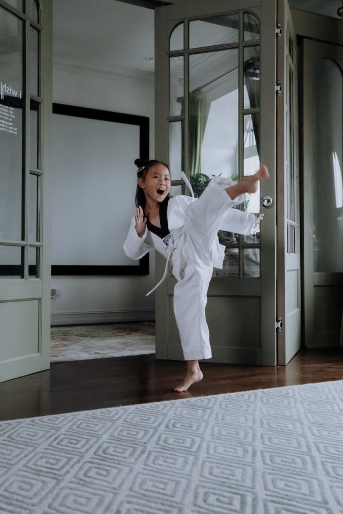 a girl in karategi practicing her martial arts