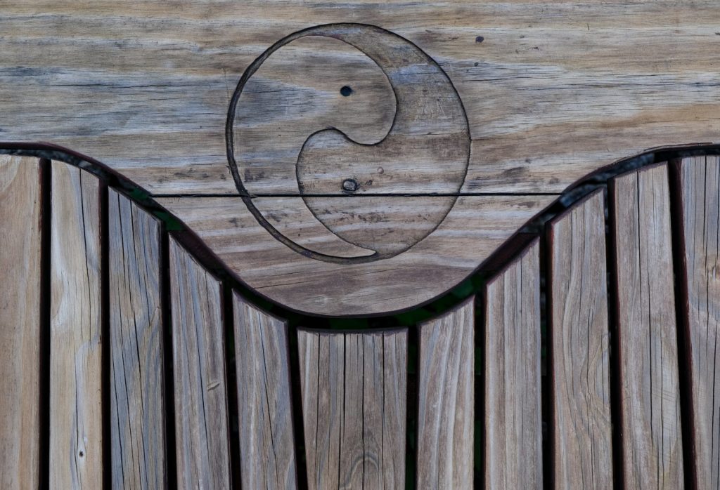 a yin and yang symbol on a wooden surface