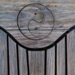 a yin and yang symbol on a wooden surface