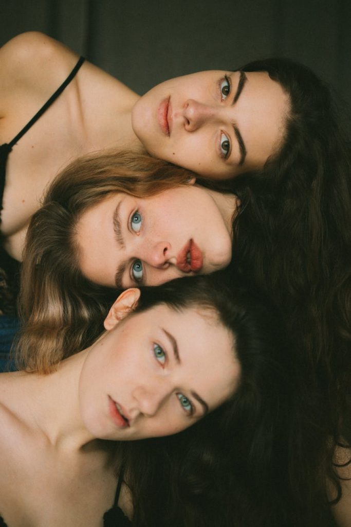 peaceful young ladies cuddling in studio