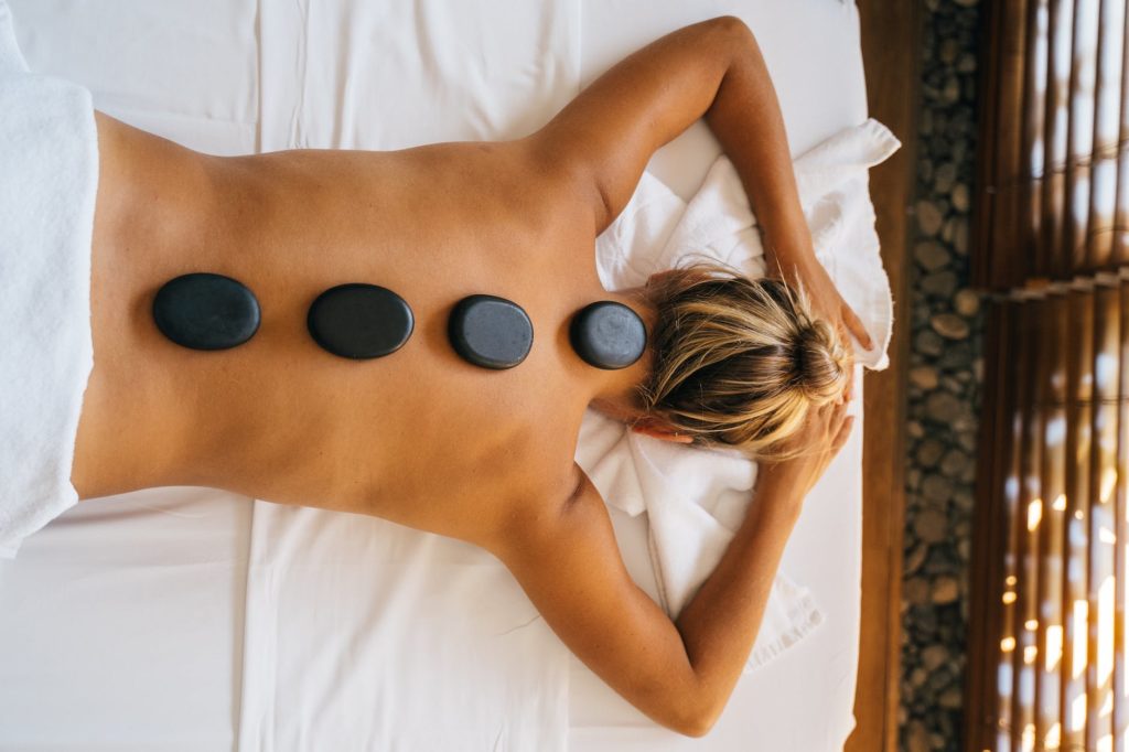 top view of a person with hot stones on their back