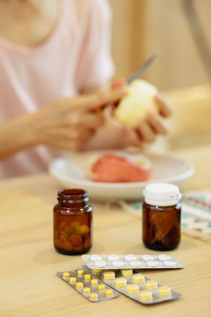 woman suffering from disease at table with medicines