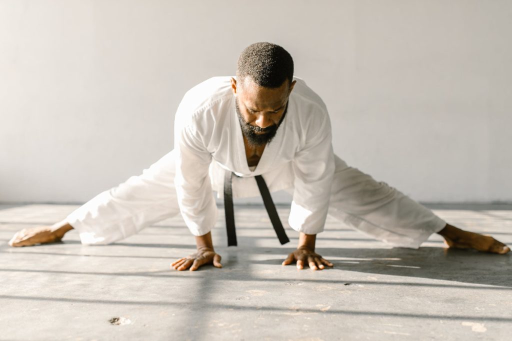 a martial artist doing a leg split