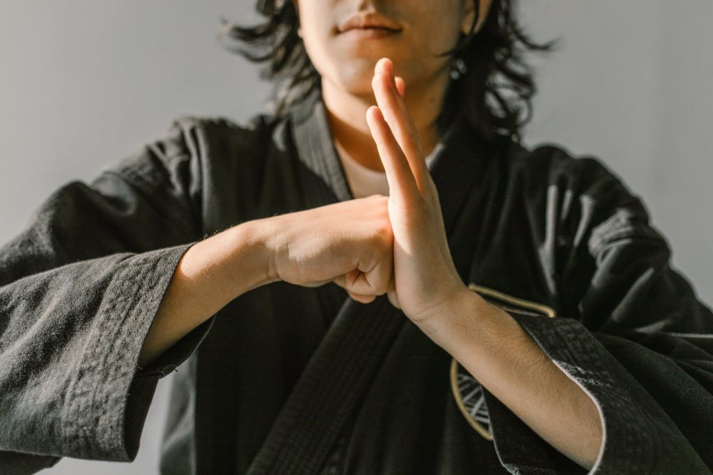 man in gray robe practicing martial art