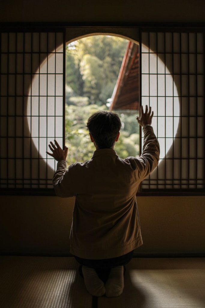 man looking through round window