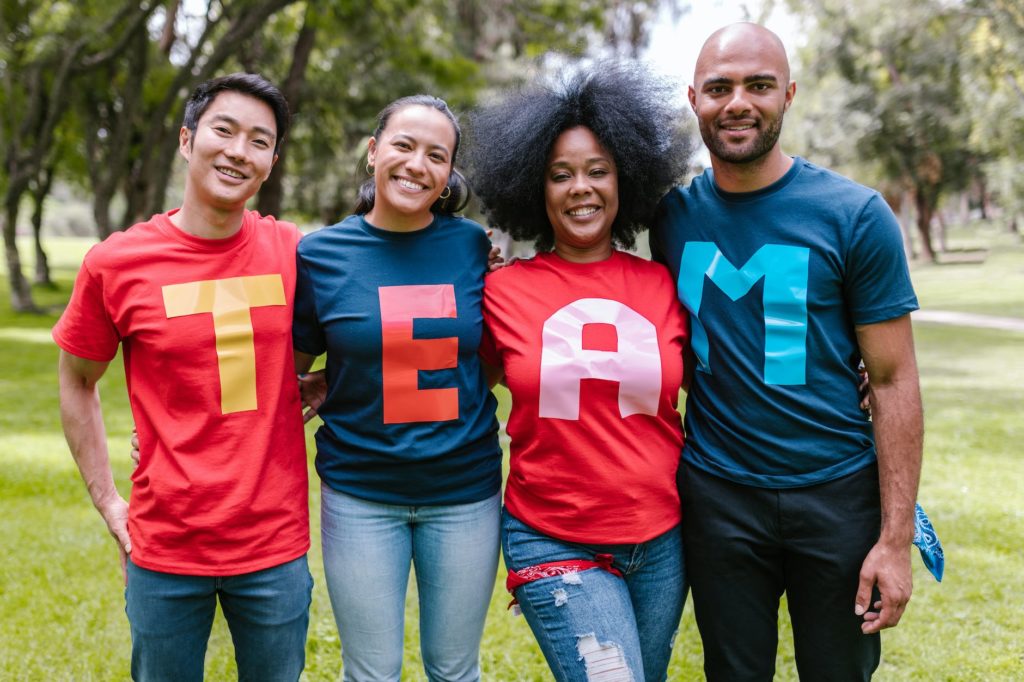 group of people wearing shirts spelled team