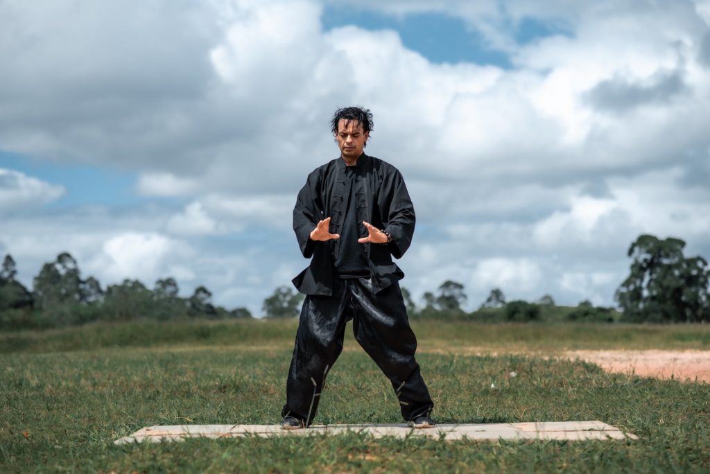 man in black clothes with his eyes closed