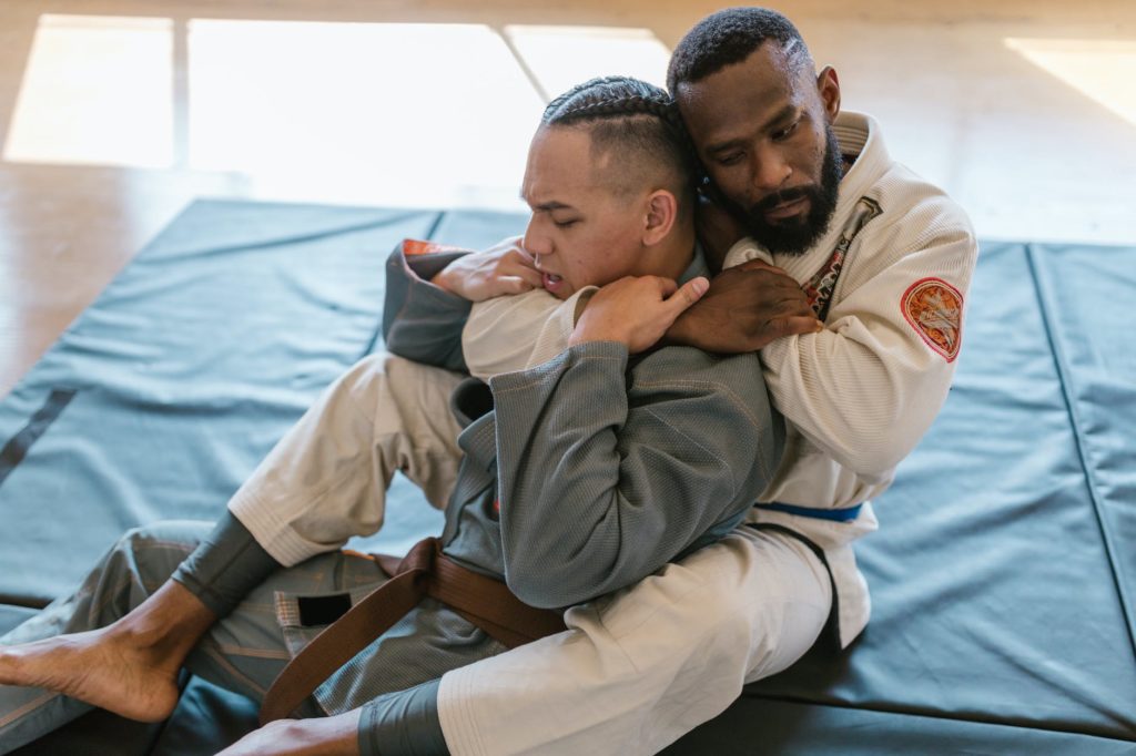 martial artists fighting in close up photography