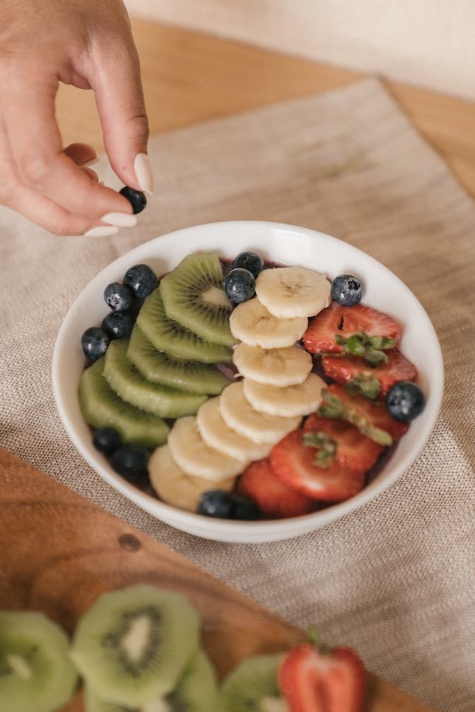 sliced fruits in white ceramic bowl