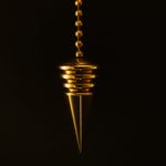 hanging gold colored pendant with necklace