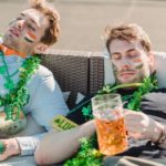 exhausted drunk guys sleeping together on sofa after hangout