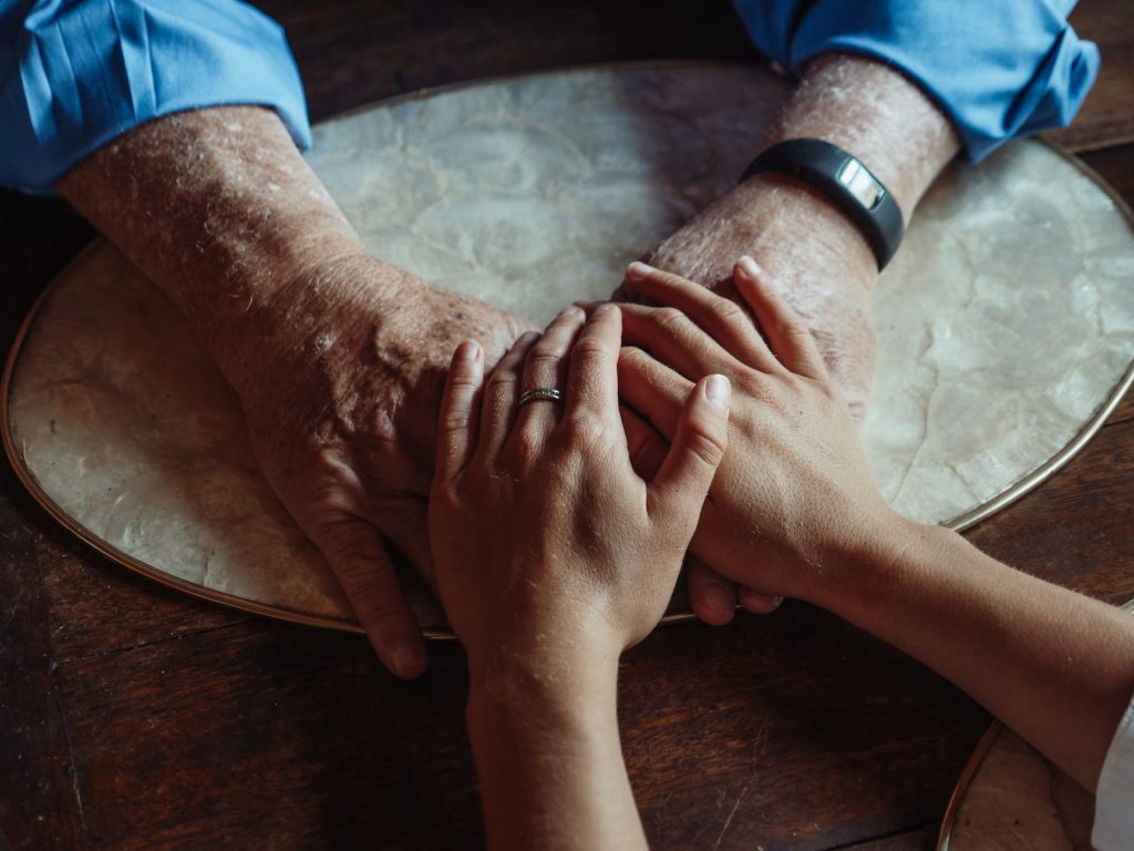 a close up shot of people holding hands