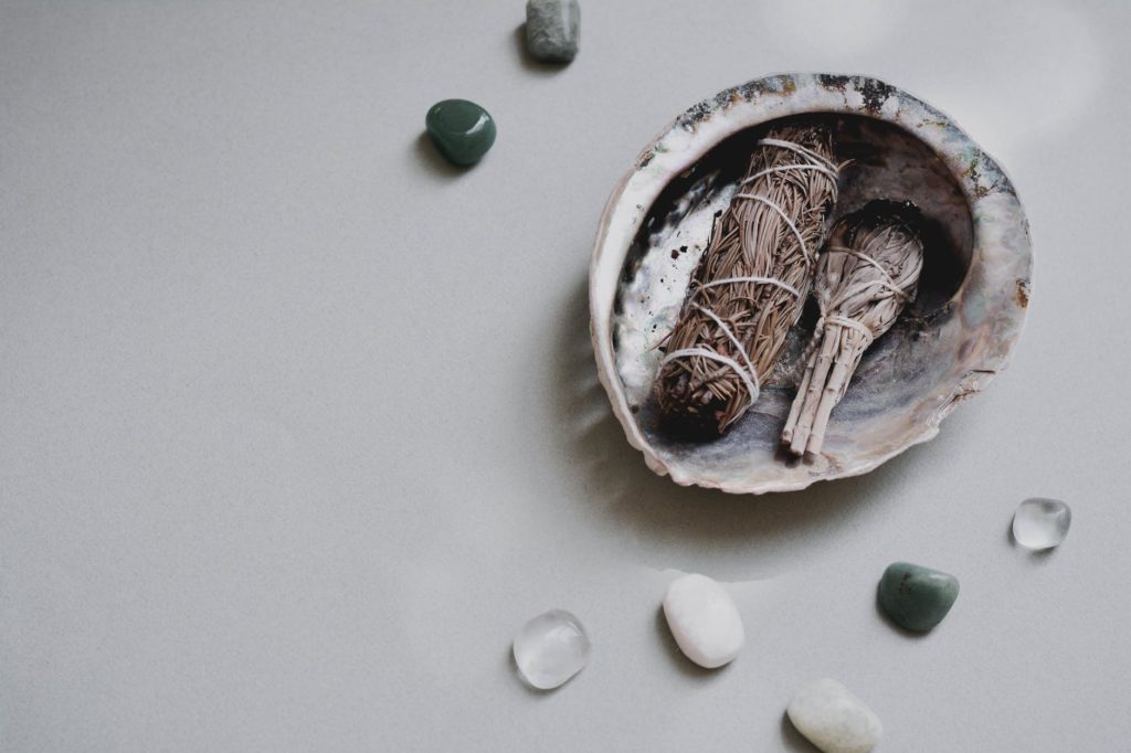 close up shot of gemstones beside a shell