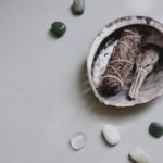 close up shot of gemstones beside a shell