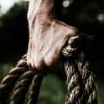 man holding brown rope