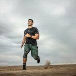 man running on sand field