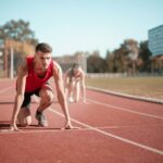 strong sportsmen ready for running on stadium