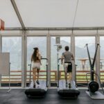 man and woman exercising on a treadmill at the gym