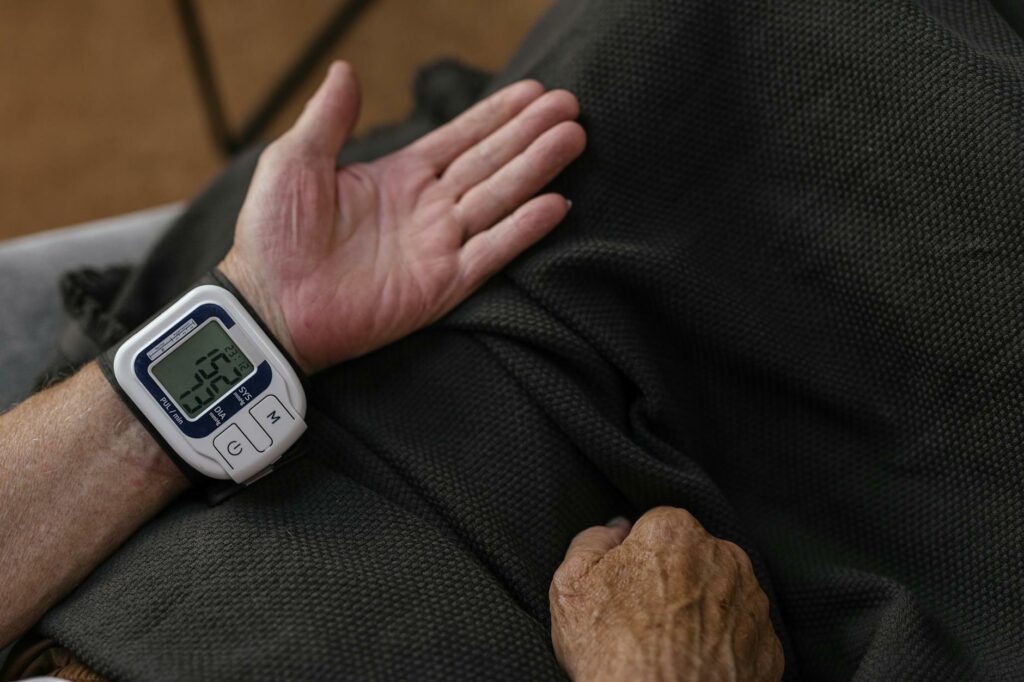 a person measuring his own blood pressure using a wrist blood pressure meter