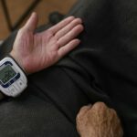 a person measuring his own blood pressure using a wrist blood pressure meter